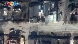 This satellite image released by Maxar Technologies on April 4, 2022 shows a view of Yablonska Street in Bucha, Ukraine, on March 19, 2022. The photograph disproves Russian claims that the bodies had been staged after Russian withdrawal. (<I>&#</i>169;2022 Maxar Technologies / AFP)