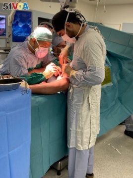Dr. Bassam Osman (right) working under the supervision of his mentor, Dr. Jamil Borgi (far back of the photo). (Courtesy photo from Dr. Bassam Osman)