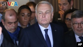 French Foreign Minister Jean-Marc Ayrault (center) arrives at Charles de Gaulle airport's Mercure hotel where passenger relatives have been met by EgyptAir representatives.