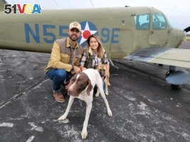 Pilot Eduard Seitan and his fiancee, Debbie, in front of his plane. They are preparing to deliver rescue dogs to their new home.