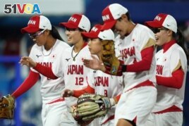Team Japan shortstop Mana Atsumi (12) celebrates with teammates after an inning ending double play against the United States of America during the sixth inning in the gold medal game of the Tokyo 2020 Olympic Summer Games at Yokohama Baseball Stadium. (Kareem Elgazzar-USA TODAY Sports)