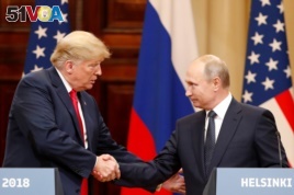 U.S. President Donald Trump and Russian President Vladimir Putin shake hands as they hold a joint news conference after their meeting in Helsinki, July 16, 2018.