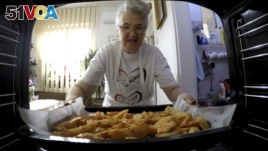  Granny's Kitchen: Jelena Petrovic places the tray with food into the oven