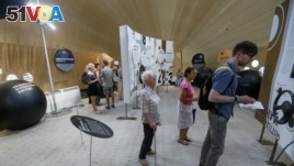 Visitors read information about corruption inside a giant tent, at the 