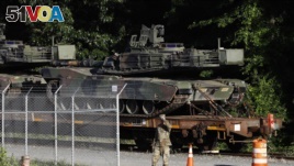 Military police walk near Abrams tanks on July 1, 2019, in Washington, DC. President Donald Trump says the Fourth of July celebration there will include military hardware. (AP Photo/Patrick Semansky)