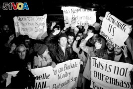 Americans who support Iran's position in the hostage crisis join with Iranians in anti-American demonstrations outside the U.S. Embassy in Tehran , Dec. 15, 1979. (AP Photo/Mohammad Sayad)
