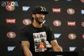 San Francisco 49ers quarterback Colin Kaepernick answers questions at a news conference after an NFL preseason football game against the Green Bay Packers.