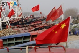FILE - China's national flags are seen on fishing boats preparing for spring fishing in Lianyungang, Jiangsu Province, China, March 26, 2016.