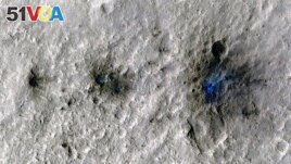 This undated photo released by NASA shows craters that were formed by a Sept. 5, 2021, by a meteoroid impact on Mars, the first to be detected by NASA's InSight lander. (NASA/JPL-Caltech/University of Arizona via AP)