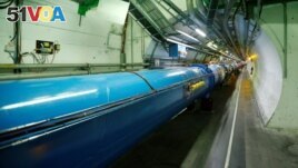 FILE - The Large Hadron Collider (LHC) tunnel is pictured at The European Organization for Nuclear Research (CERN) in Saint-Genis-Pouilly, France, March 2, 2017. (REUTERS/Denis Balibouse)