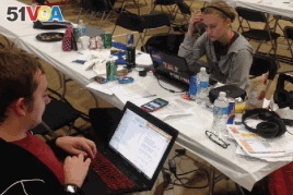Tyler Skluzacek and another team member at a competition called HackDC, a 36-hour coding competition, teamed up with two other participants from other universities to create the myBivy smartphone/smartwatch application, in Washington, D.C. (Courtesy photo