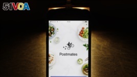 This Tuesday, Feb. 20, 2018, photo shows the Postmates app on an iPhone in Chicago. (AP Photo/Charles Rex Arbogast)
