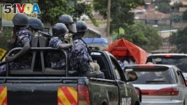In this file photo, Ugandan riot police patrol on the streets of the Kamwokya neighborhood.