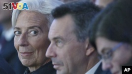 Managing Director of the International Monetary Fund Christine Lagarde, left, attends the plenary session of the World Economic Forum in Davos, Switzerland, Jan. 20, 2016. 