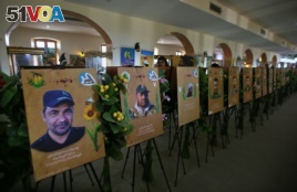 In this Friday, Feb. 1, 2019 photo, commemorative images of militiamen who died fighting the Islamic State group over the past four years, and their weapons are on display in the Popular Mobilization Forces War Museum on al-Mutanabi Street, Baghdad, Iraq.