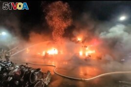 In this image taken from video by Taiwan's EBC, firefighters battle a blaze at a building in Kaohsiung, in southern Taiwan, Oct. 14, 2021.