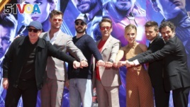 FILE - Marvel Studios President Kevin Feige, from left, poses with members of the cast of 