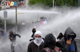 Demonstrators are sprayed by riot police water canons during a protest against Chile's government in Concepcion, Chile October 31, 2019. REUTERS/Jose Luis Saavedra