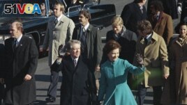 FILE - This Jan. 20, 1977 file photo shows President Jimmy Carter and First Lady Rosalynn Carter waving as they walk down Pennsylvania Avenue in Washington after Carter was sworn in as the nation's 39th president.