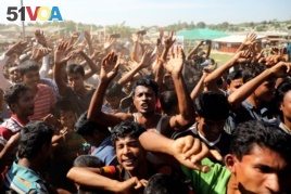 Hundreds of Rohingya refugees shout slogans as they protest against their repatriation at the Unchiprang camp in Teknaf, Bangladesh