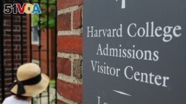 FILE - A sign points the way to the Harvard College Admissions Visitors Center at Harvard University in Cambridge, Massachusetts, U.S., July 6, 2023. (REUTERS/Brian Snyder)