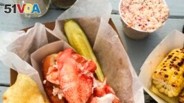 This image released by Goldbelly shows a lobster roll from McLoons Lobster Shack in Maine. (Goldbelly via AP)
