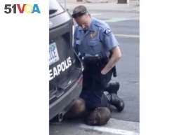 FILE - In this Monday, May 25, 2020, file frame from video provided by Darnella Frazier, a Minneapolis officer kneels on the neck of George Floyd, a handcuffed man who was pleading that he could not breathe.