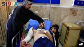 A victim of a bombing attack receives treatment at the Imam Ali Hospital in Sadr City, Baghdad, Iraq, Feb. 29, 2016.