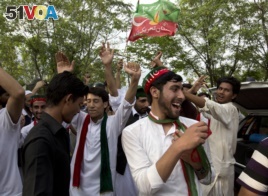 Supporters of politician Imran Khan, chief of the Pakistan Tehreek-e-Insaf party, dance to celebrate the victory of their party candidate, outside their leader's home in Islamabad, Pakistan, Thursday, July 26, 2018.