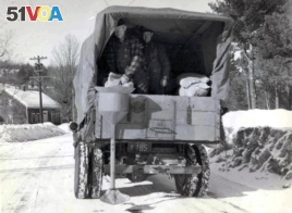 This circa 1940s photo released by the New Hampshire Department of Transportation archives shows salt being applied for anti-icing on a New Hampshire roadway.