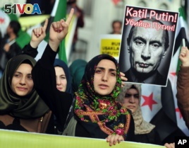 Turkish protesters shout anti-Russia slogans as they hold a poster of Russian President Vladimir Putin during a protest in Istanbul, Turkey, Nov. 27, 2015.  (AP Photo/Omer Kuscu)      
