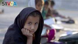 FILE - Pakistani student Farah Muneeb sits with other students at a makeshift school set up by a volunteer in a park in Islamabad, Pakistan on Thursday, Oct 11, 2012. 