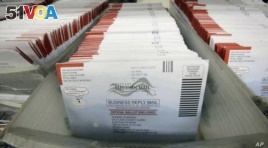 FILE - In this Nov. 1, 2016, file photo, mail-in ballots for the 2016 General Election are shown at the elections ballot center at the Salt Lake County Government Center, in Salt Lake City.