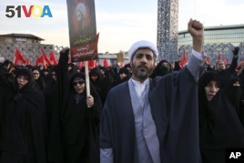 A Muslim cleric chants slogans alongside women in a rally to protest the execution by Saudi Arabia last week of Sheikh Nimr al-Nimr, a prominent opposition Saudi Shiite cleric, in Tehran, Iran, Jan. 4, 2016. (AP Photo/Vahid Salemi)