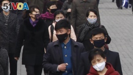 People wear face mask amid the concern over the spread of the coronavirus in Pyongyang, North Korea, Wednesday, April, 1, 2020. 
