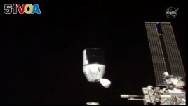 FILE- This photo provided by NASA shows SpaceX's Dragon undocking from International Space Station on Tuesday, Jan. 12, 2021. 