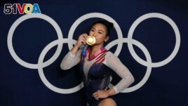 Sunisa Lee, of United States, reacts as she poses for a picture after winning the gold medal in the artistic gymnastics women's all-around final at the 2020 Summer Olympics, Thursday, July 29, 2021, in Tokyo, Japan. (AP Photo/Gregory Bull)