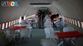 Palestinians visit a Boeing 707 after the plane was converted to a cafe restaurant, in Wadi Al-Badhan, near the West Bank city of Nablus, Wednesday, Aug. 11, 2021. (AP Photo/Majdi Mohammed)