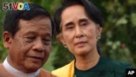 Leader of the National League for Democracy (NLD) party Aung San Suu Kyi, right arrives to participate in a gathering with newly elected lawmakers of NLD on Thursday, March 10, 2016 in Naypyitaw, Myanmar. 