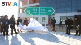 South and North Korean officials unveil the sign of Seoul to Pyeongyang during a groundbreaking ceremony for the reconnection of railways and roads at the Panmun Station in Kaesong, North Korea, December 26, 2018.