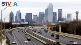 This Friday, Jan. 14, 2011, file photo shows highway traffic with the Dallas skyline in the background. (AP Photo/Tony Gutierrez, File)