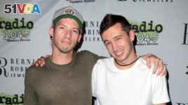 Josh Dun, left, and Tyler Joseph of the band Twenty One Pilots pose for photographers backstage during the Radio 104.5 9th Birthday Show at BB&T Pavilion on Saturday, June 11, 2016, in Camden, N.J.