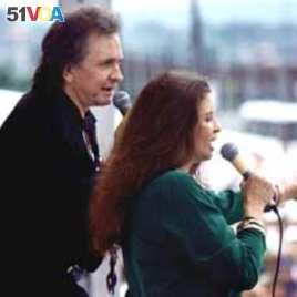 Country music legend Johnny Cash performs with his wife June Carter Cash, a member of the famous Carter Family.