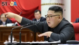 This picture taken during the period of December 28 to December 31, 2019 and released from North Korea's official Korean Central News Agency (KCNA) on January 1, 2020 shows North Korean leader Kim Jong Un attending a session of the 5th Plenary...