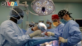 FILE - A medical team performs hernia surgery in an operating room near Riohacha, Colombia, Nov. 27, 2018. 
