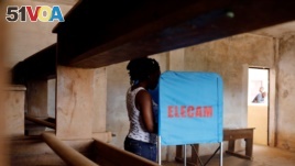 FILE - A woman casts her vote at a polling station during elections, in Yaounde, Cameroon, Oct. 7, 2018.