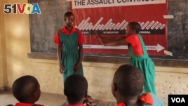 Schoolgirls practice how to protect themselves from assault at one of the classes Ujamaa Pamodzi Africa offers in Malawi
