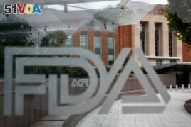 This Aug. 2, 2018, file photo shows the U.S. Food and Drug Administration building behind FDA logos at a bus stop on the agency's campus in Silver Spring, Md. (AP Photo/Jacquelyn Martin, File)