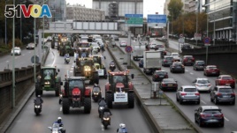 Farmer drive their tractors on the Paris ring road in Paris, France, Nov. 27, 2019.