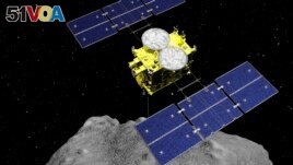 This computer graphics image released by the Japan Aerospace Exploration Agency (JAXA) shows the Hayabusa2 spacecraft above the asteroid Ryugu. (ISAS/JAXA via AP)